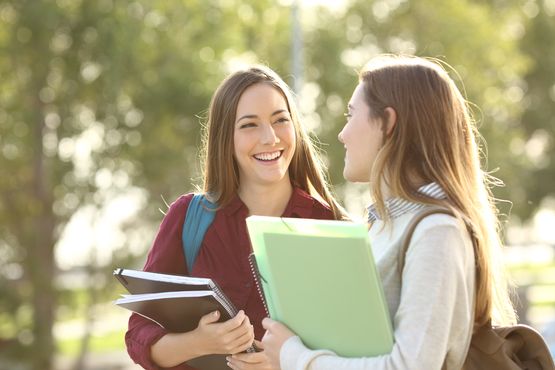 two happy students discussing their results 